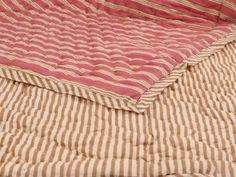 two bedspreads with red and white stripes on them