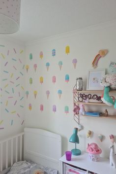 a child's room decorated with ice cream and sprinkles on the wall