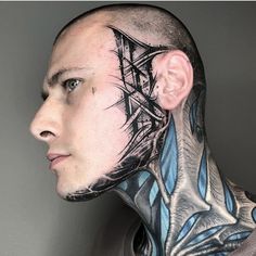 a man with tattoos on his face and neck