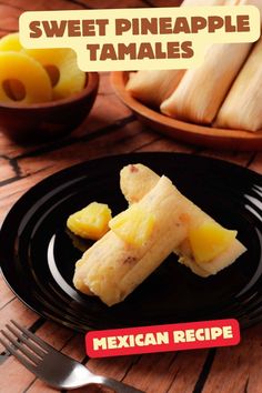 a black plate topped with sliced pineapple tamales next to a bowl of mangoes