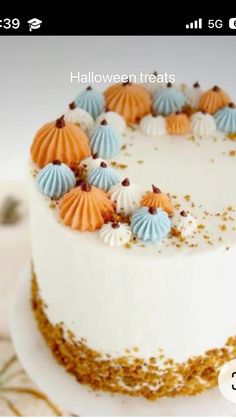 a white cake with orange, blue and white frosting on it's top