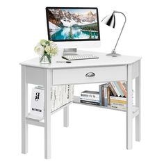 a white desk with a computer on it and bookshelves underneath the desk top