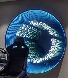 a computer chair sitting in front of a neon sign