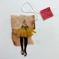 a piece of paper with an image of a woman wearing a yellow tutu skirt