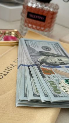 a stack of money sitting on top of a table