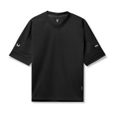 Mesh hockey-style jersey in an oversized fit. Designed to be worn as a throw-over during warm-ups or as a standalone shirt. Constructed from a SilverPlus™ mesh, providing natural breathability with anti-odor properties. Featuring 6” high side splits for maximum range of motion and red bar tacks for durability. The back Black Breathable Jersey For Streetwear, Breathable Black Baseball Jersey For Streetwear, Technical Black Top For Light Sports, Black Technical Top For Light Sports, Technical Top For Light Sports In Black, Black V-neck Top For Sportswear, Black V-neck Sportswear Top, Oversized Black Tops For Sports, Breathable Sportswear Jersey For Streetwear