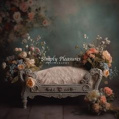 a white couch with flowers on it in front of a wall that says simply pleasure photography