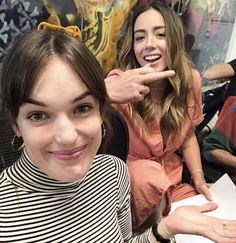 two young women sitting next to each other