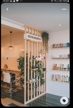 a hair salon with shelves and plants on the wall next to it's doors