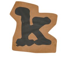 the letter k is made out of cardboard and has black paint on it's upper half