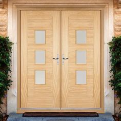 two wooden doors sitting next to each other on top of a stone flooring area