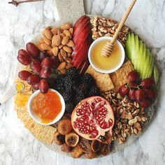 an assortment of fruits and nuts arranged on a platter