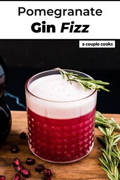 pomegranate gin fizz in a coupe glass with rosemary garnish