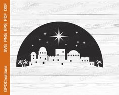 a black and white christmas scene with a star above the city, on wood planks