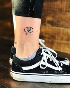 a woman's foot with a small tattoo on her left ankle and the word i love