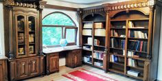 a large wooden bookcase sitting next to a window