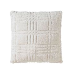 a white pillow with squares and lines on the front, sitting on a white surface