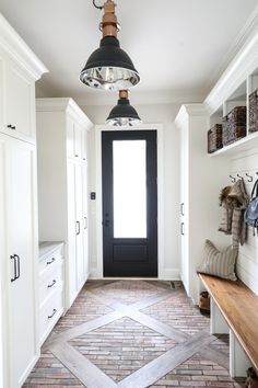 an instagram page with a black door and white cabinets in the hallway, next to a wooden bench