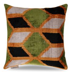 an orange, green and black pillow on a white background