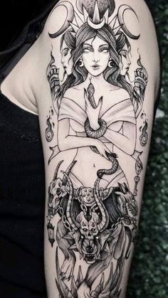 a woman's arm with tattoos on it, and an image of a demon