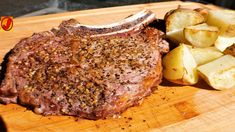 a steak and potatoes on a cutting board