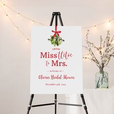 a sign that is on top of a easel in front of a christmas tree