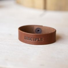 This personalized leather wrap bracelet has been handcrafted and embossed using USA source leather from Law Tanning. It comes with your custom initials, name, and symbol heat-stamped into the leather. This bracelet is perfect for both men and women. This bracelet is a custom jewelry piece that pairs well on casual and dress-up days. Looks great with both long and short sleeve shirts and adds a natural element to add to your jewelry collection. It will also be a great bracelet to wear alone or st Dress Up Day, Natural Element, Leather Cuff Bracelet, Leather Company, Leather Cuffs Bracelet, Custom Initials, Leather Wrap Bracelet, Leather Cuffs, Everyday Carry