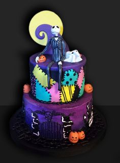 a three tiered cake decorated with halloween decorations