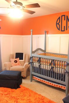 a baby's room with an orange and blue theme