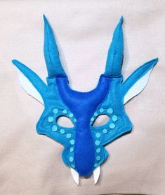 a blue mask with horns and dots on it