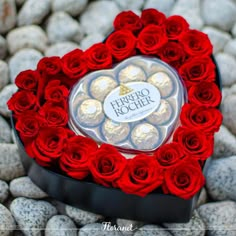 a heart shaped box filled with chocolates and roses