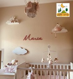 a baby's room with teddy bears and other items hanging from the ceiling, including a crib