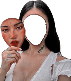 a woman holding up a mirror to her face with scissors on it's sides