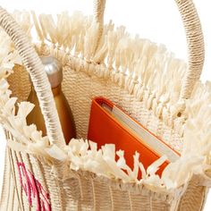 a white basket filled with items on top of a table