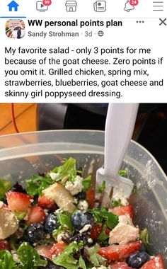 a salad in a bowl with blueberries, strawberries, and cheese on it