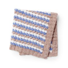 two blue and white knitted dishcloths on top of each other, one with a button in the middle