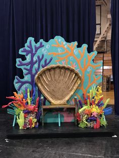 the stage is decorated with colorful corals and seashells