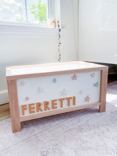 a wooden box with the word ferretti spelled out in gold letters on it