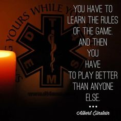 a lit candle next to a wall with an image of a cross on it and the words, you have to learn the rules of the game and then you have to play better than anyone else