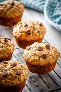 several muffins cooling on a rack with chocolate chips