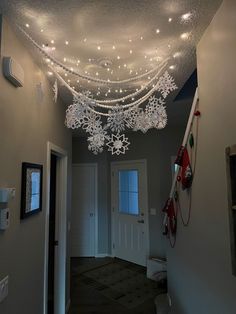 a hallway decorated with lights and snowflakes