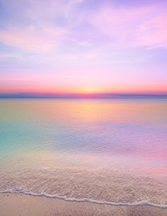 the sun is setting over the water at the beach