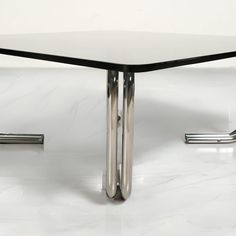 a white table with chrome legs on it