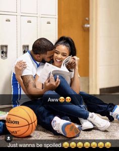 a man and woman sitting next to each other on the floor with basketballs around them