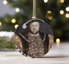 a christmas ornament with a portrait of king henry iv on it's front