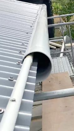 a metal pipe on the side of a building