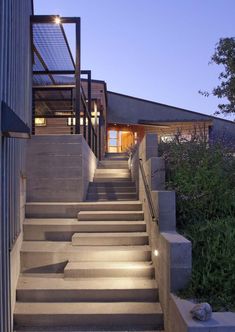 stairs leading up to a house with solar panels on the roof