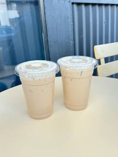 two plastic cups sitting on top of a table