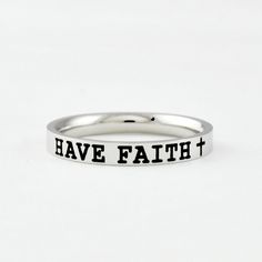 "This listing is for one stainless steel band ring, engraved with \"HAVE FAITH\" + a cross sign on the outside.  It makes a best gift for friends, sisters in Christ or yourself. Always be reminded to embrace faith over fear. Materials & Features: This ring is made of high quality hand polished solid stainless steel, which is hypoallergenic (good for metal-sensitive skin). Stainless steel will not tarnish, its luster and durability will make it last for many years. The black text on the ring will not fade out over time. Sizes: This ring is 3mm wide, dainty and cute, with smooth rounded edge on the inside for comfort fit. Please Note: The text is engraved on a 3 mm wide ring which is made of high-polished stainless steel with a mirror-like effect, so the visibility of the text may vary under Cross Sign, Sisters Best Friends, Faith Cross, Sorority Sisters, Stacking Bands, Wide Ring, Fade Out, Wide Rings, Cross Ring