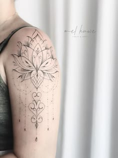 a woman's arm with a tattoo on it that has an intricate flower design